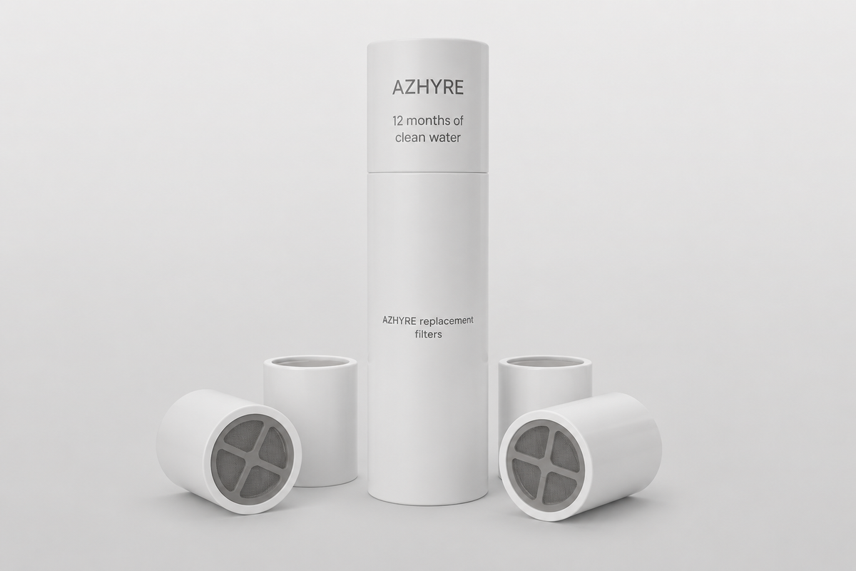 A white cylindrical AZHYRE filter canister stands upright in the center with four matching white filter cartridges arranged around it on a clean light gray studio background.